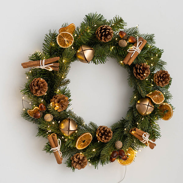 Artificial Christmas wreath with dried orange slices cinnamon sticks and pine cones, vintage winter Christmas wreath